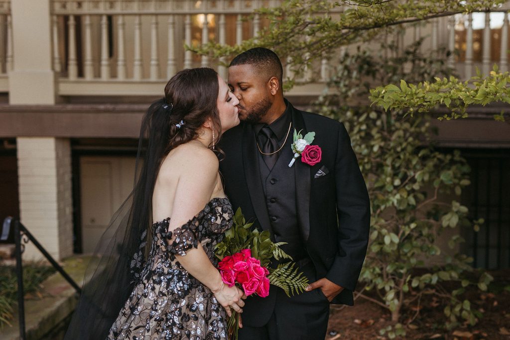 Alissa and CJ sharing a kiss during their couple portraits