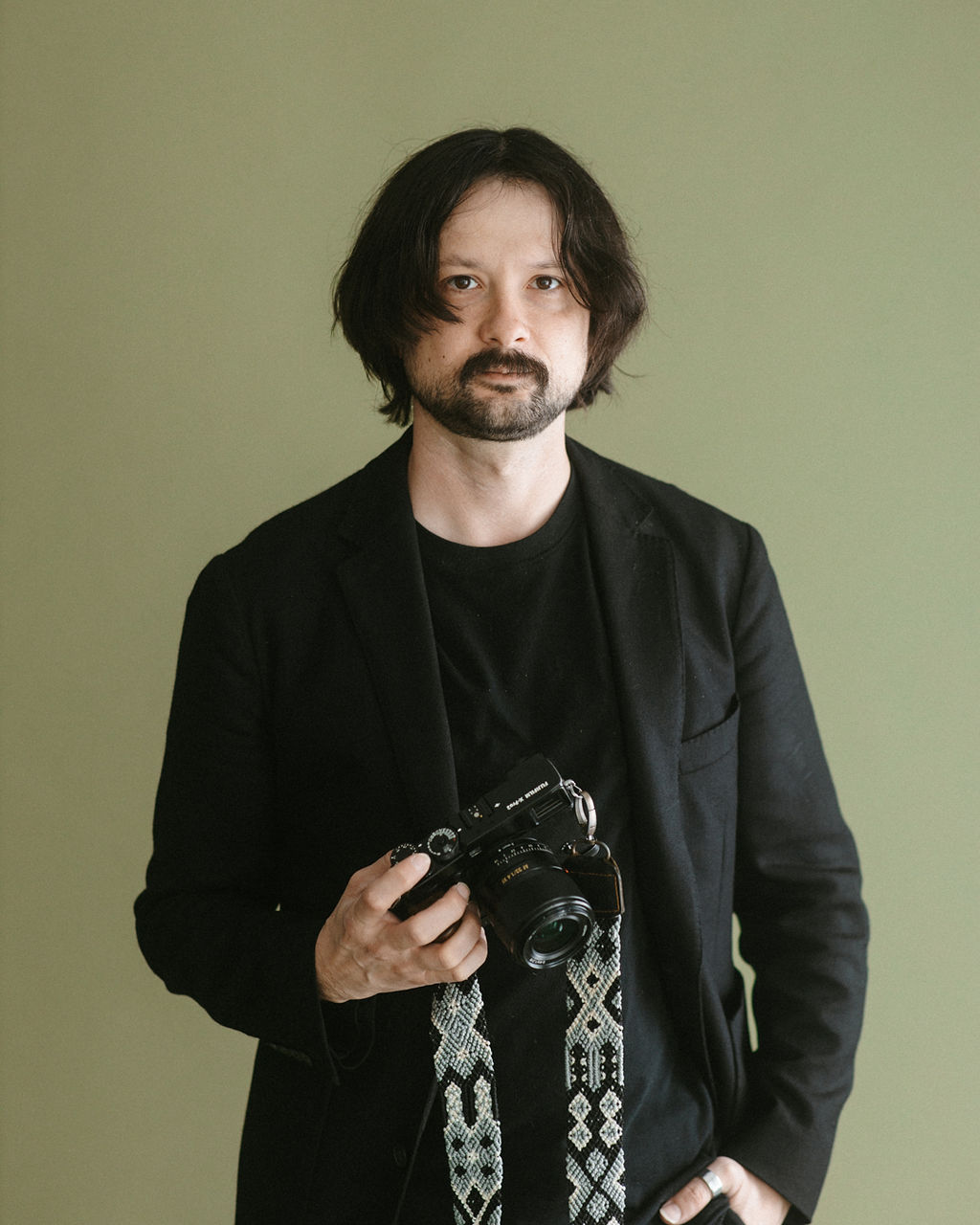 Ardy Wunder, wedding photographer at Eternally Yours, holding a camera