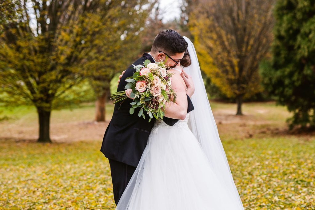 Mel and Josh sharing a kiss during their couple portraits