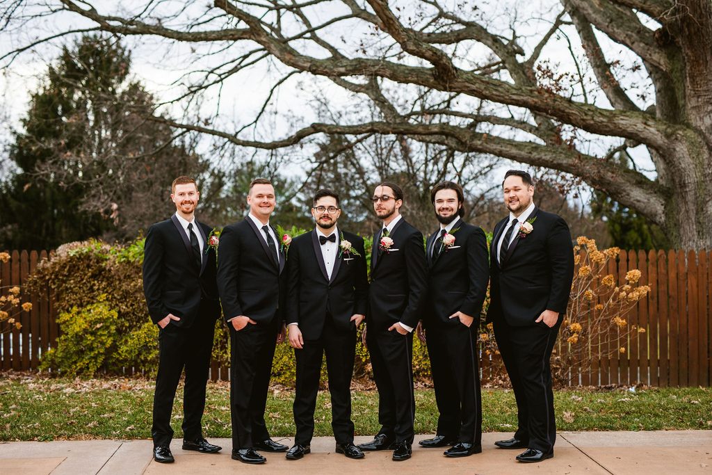Mel and Josh with loved ones on their wedding day